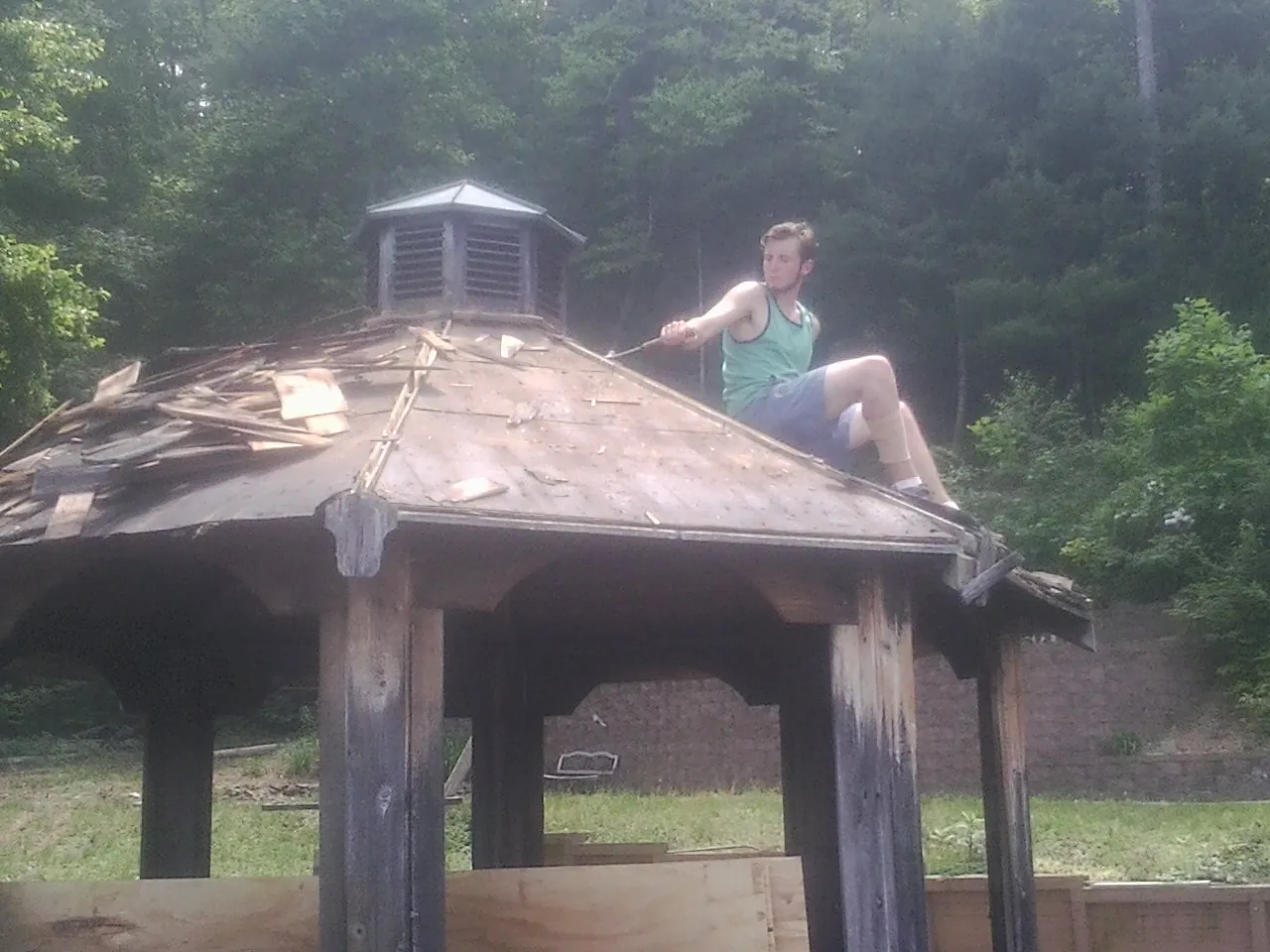 Tearing the old roof off a wooden gazebo before new shakes in Haddon Heights