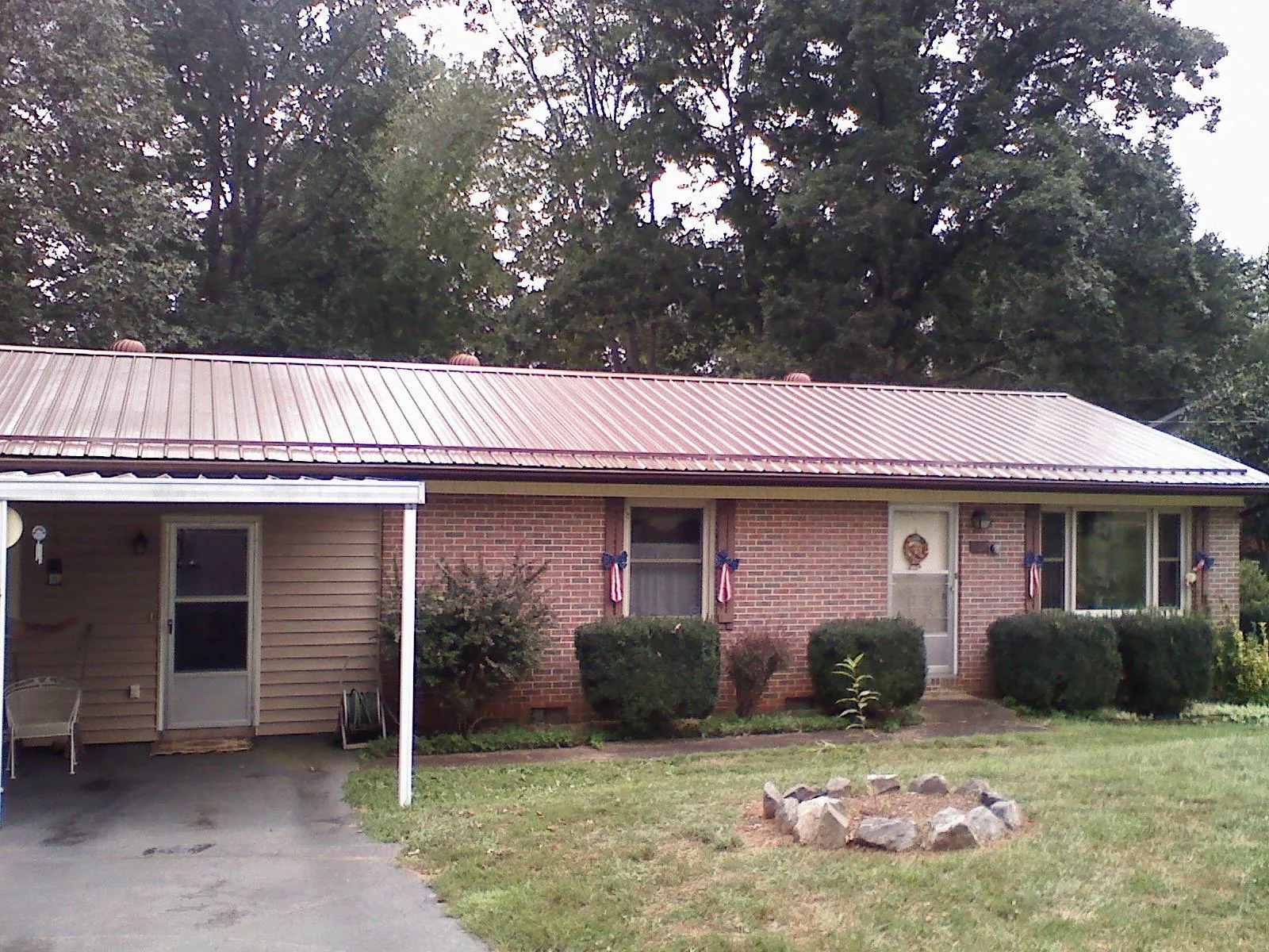 Bronze metal roof and carport on a brick ranch home — Roof Repair work by our crew in Haddon Heights